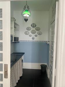 a bathroom with a blue wall with plates on the wall at Sto António Vintage Studio in Porto