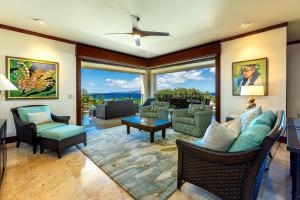 a living room with furniture and a large window at Wailea Beach Villas M312 condo in Wailea