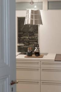 a kitchen with a table with a lamp and a counter at Stadthaus Monschau Aqua&Blue (14 Gäste) in Monschau