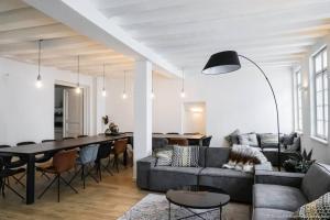 a living room with a couch and a table at Stadthaus Monschau Aqua&Blue (14 Gäste) in Monschau