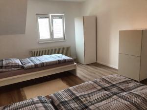 a bedroom with two beds and a window at Apartmán Neva Gbely in Skalica