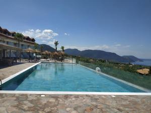 a pool at a resort with a view of the ocean at Hotel Anthidon Estate in Chalkida
