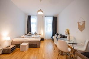 a bedroom with a bed and a couch and a table at My city apartment vienna- one Bedroom in Vienna