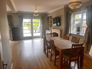 a dining room with a wooden table and chairs at Large Family Home with great access to M2 & London in Wainscot