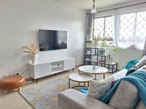 salon z kanapą i telewizorem w obiekcie Jkia 3 bedroom greatwall gardens phase 4 w mieście Athi River