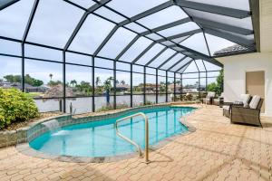 einen Innenpool mit Glasdecke und eine Terrasse in der Unterkunft Private Pool, Dock and Gulf Access Cape Coral Home! in Cape Coral