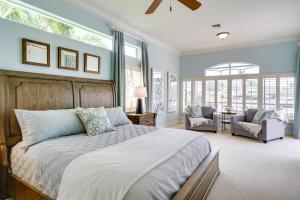 ein Schlafzimmer mit einem großen Bett und zwei Stühlen in der Unterkunft Private Pool, Dock and Gulf Access Cape Coral Home! in Cape Coral + 24 Fotos