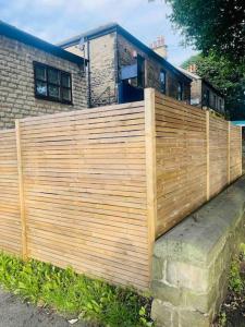 a wooden fence in front of a house at Cosy flat close to city centre. in Nether Edge