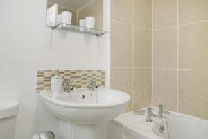 a bathroom with a sink and a toilet and a tub at Lovely 2-Bedroom Home in Langley Park, Sleeps 4 in Durham