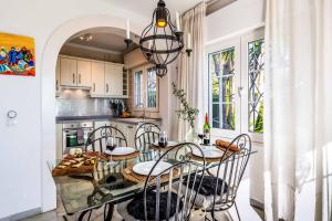 a dining room with a table and chairs in a kitchen at Casa Los Olivos in Nerja