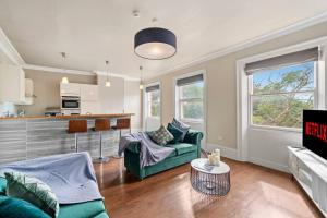 a living room with a couch and a table at Exquisite Georgian Apartment with Reserved Parking in Wakefield