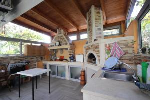 a kitchen with a stove and a sink in a house at Mato Rooms in Himare