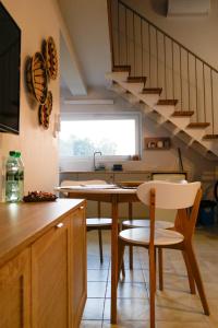 a kitchen with a table and chairs and stairs at Harmonia Horyniec in Horyniec