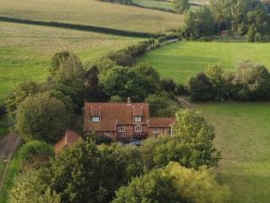 an aerial view of a house in a field at Locks Lane Cottage in Geldeston