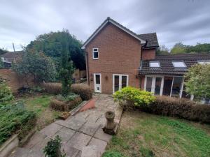 a large brick house with a yard with a courtyard at 5 bedroom, recently renovated house close to Hastings Beach in Hastings