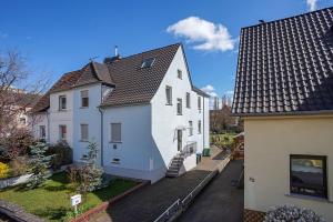 a view of two white houses with roofs at FeWo beim Schlafhaus in Völklingen