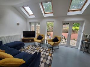 a living room with a blue couch and chairs at 5 bedroom, recently renovated house close to Hastings Beach in Hastings