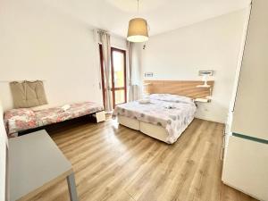 Postel nebo postele na pokoji v ubytování Vittoria Apartament