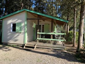 a small white shed with a green roof at La Vallée De Taradeau in Taradeau