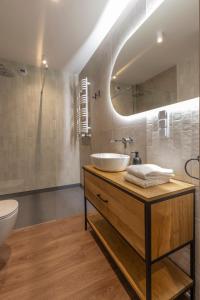 a bathroom with a sink and a mirror at River Side Residence 3/19 in Oświęcim +16 photos