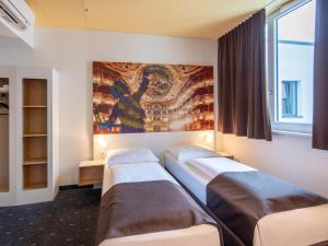 Postel nebo postele na pokoji v ubytování B&B Hotel Bayreuth + 21 fotografií