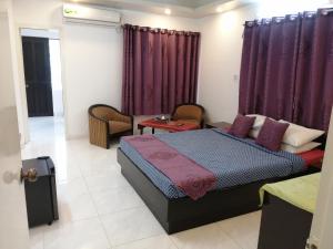 a bedroom with a bed and purple curtains at Bay Marina Cox's Bazar in Kelātali