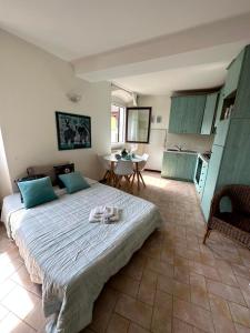 a bedroom with a large bed and a kitchen at Beautiful View in Bergamo