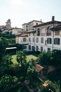 a view of a building with a lawn and trees at Beautiful View in Bergamo