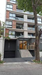 a large building with stairs and a building at 2 Dormitorios en Villa Morra in Asunción