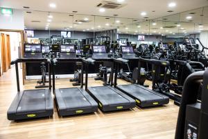 a gym with several rows of tread machines at Crowne Plaza Reading in Reading