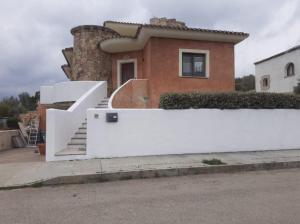 a house with a white fence in front of it at Mi Casita in Arzachena
