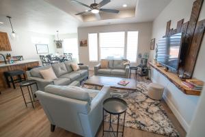 a living room with a couch and a tv at Hollywood Hangout - New West Properties in Kanab