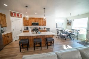 a kitchen and dining room with a large island in the middle at Hollywood Hangout - New West Properties in Kanab