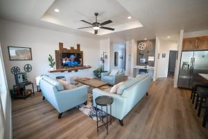 a living room with two couches and a table at Hollywood Hangout - New West Properties in Kanab