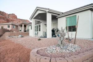 a cactus statue in front of a house at Hollywood Hangout - New West Properties in Kanab