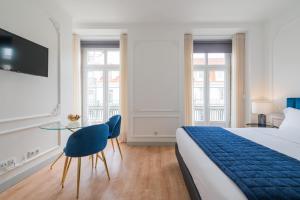 a hotel room with a bed and a table at Via Augusta 129 in Lisbon