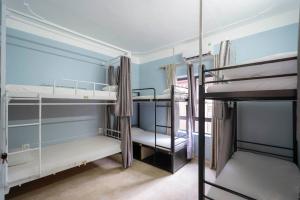 a room with three bunk beds in it at Fancy Hostel and Bar in Ha Long