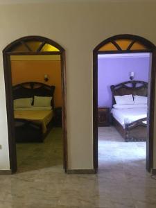 two mirrors in a room with two beds at Tibs mountain view in Al Aqālitah