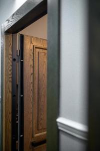 a reflection of a wooden door in a mirror at City Loft 5 (Stamatina's Luxury Apartments) in Alexandroupoli