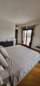 a large bed in a room with a window at Mi Casita in Arzachena