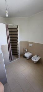 a bathroom with a toilet and a sink and a shower at Mi Casita in Arzachena +8 photos