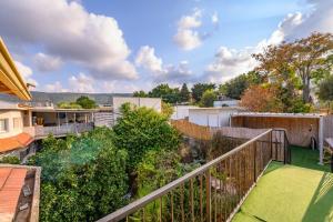 a view from the balcony of a house with a yard at העוגן והים - The Anchor and the Sea in Shlomi