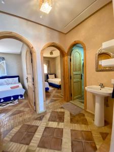 a bedroom with a bed and a sink in a room at Dar diafa samira in Mirleft +37 photos