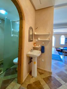 a bathroom with a sink and a toilet at Dar diafa samira in Mirleft