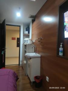 a bathroom with a sink in a room at APARTEMEN GRAND DHIKA 2325 BEKASI TIMUR in Padurenan