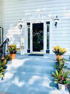 a front door of a house with potted plants at Speedway Legacy Inn in Indianapolis