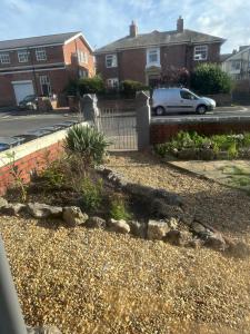 a yard with a fence and a car in a driveway at Blackpool Rocks Pleasure Beach in Blackpool