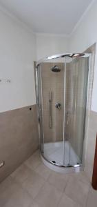 a shower with a glass enclosure in a bathroom at Mi Casita in Arzachena
