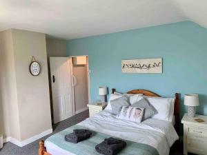 a bedroom with a bed with two towels on it at Shipmeadow Cosy Cottage in Beccles