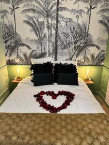 a bed with a heart of flowers on it at Le Lamartine - Vue Saône - Hypercentre in Mâcon